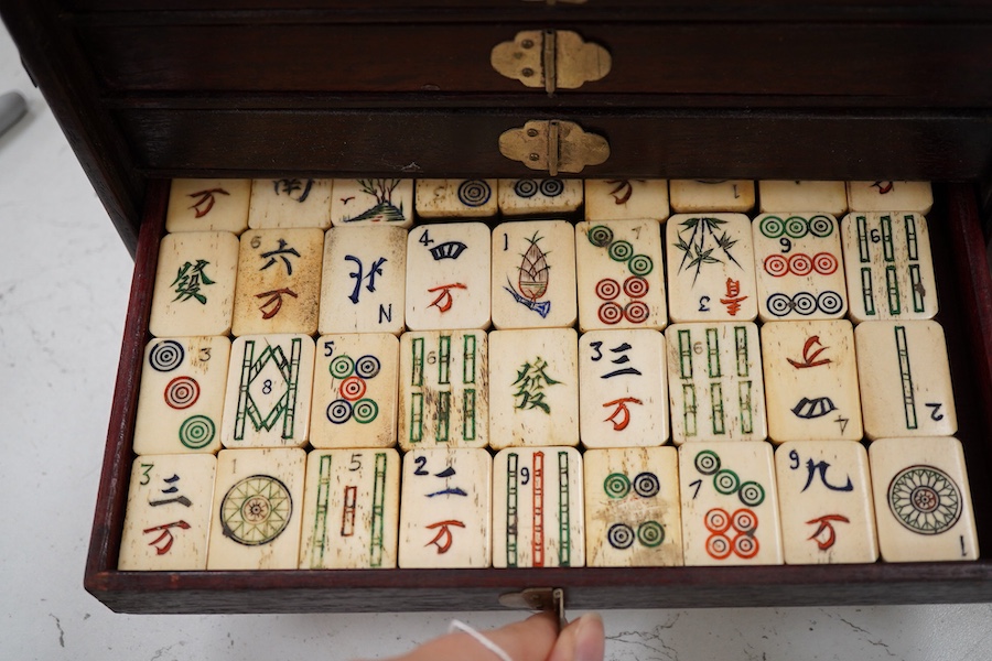 A Chinese bone and bamboo Mah-Jong set, 24cm wide